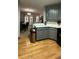 Eat-in kitchen features gray cabinets, stainless appliances, and hardwood floors at 3148 Glenloch Pl, Lawrenceville, GA 30044