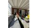Covered patio with a comfortable sofa, stylish table decor, and access to the home at 3148 Glenloch Pl, Lawrenceville, GA 30044