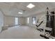 Bright basement featuring ceiling tiles, a door and some exercise equipment at 775 Hales Trace Sw Way, Lilburn, GA 30047