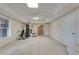 Finished basement featuring ceiling tiles and some exercise equipment at 775 Hales Trace Sw Way, Lilburn, GA 30047