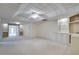 Finished basement area featuring ceiling tiles and built-in shelving at 775 Hales Trace Sw Way, Lilburn, GA 30047