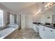 Bathroom featuring double sinks, tile floors, and a glass enclosed walk-in shower at 775 Hales Trace Sw Way, Lilburn, GA 30047