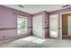Spacious bedroom featuring purple walls, window and plush carpeting at 775 Hales Trace Sw Way, Lilburn, GA 30047