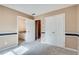 Bedroom with neutral paint and carpeted floors provides access to a full bathroom and closet at 775 Hales Trace Sw Way, Lilburn, GA 30047