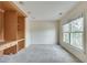 Bonus room with carpeted floors features built-in shelving and a large window at 775 Hales Trace Sw Way, Lilburn, GA 30047