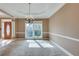 Elegant dining room featuring neutral carpet, chandelier, and natural light at 775 Hales Trace Sw Way, Lilburn, GA 30047