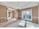 Spacious formal dining area featuring neutral carpet and an elegant chandelier at 775 Hales Trace Sw Way, Lilburn, GA 30047