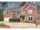 Traditional brick home with teal shutters, landscaped yard, and welcoming front entrance at 775 Hales Trace Sw Way, Lilburn, GA 30047