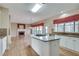 Open kitchen with white cabinets, granite counters, island, and stainless steel appliances at 775 Hales Trace Sw Way, Lilburn, GA 30047