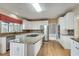 Well-equipped kitchen featuring stainless steel appliances and a large island with a cooktop at 775 Hales Trace Sw Way, Lilburn, GA 30047