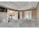 Main bedroom with carpeted floors offers access to bathroom and another room through french doors at 775 Hales Trace Sw Way, Lilburn, GA 30047
