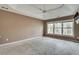 Large main bedroom features neutral paint and a large window overlooking a wooded lot at 775 Hales Trace Sw Way, Lilburn, GA 30047