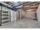 Unfinished basement space with exposed framing and storage shelving at 775 Hales Trace Sw Way, Lilburn, GA 30047