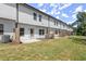 Backyard featuring a grassy lawn and a white home exterior on a sunny day at 1409 Ben Park Way, Grayson, GA 30017