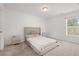 Bright bedroom with neutral carpet, a comfortable bed, and side tables for storage at 1409 Ben Park Way, Grayson, GA 30017