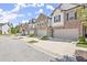 Street view of newly constructed townhomes with brick and siding exteriors, each featuring a private garage at 1409 Ben Park Way, Grayson, GA 30017