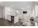 Open-concept living room and kitchen featuring modern design elements with a table and chairs, and a white sofa at 1409 Ben Park Way, Grayson, GA 30017