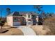 Elegant two-story stucco home with a well-manicured lawn and a paved driveway leading to an attached garage at 4197 Trotters Way Dr, Snellville, GA 30039