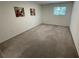 This is a well-lit bedroom with carpet, window, and modern art on the wall at 5400 Roswell Rd # K1, Atlanta, GA 30342