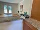 Granite countertop with views of the light-filled living room and patio doors at 5400 Roswell Rd # K1, Atlanta, GA 30342