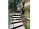 Exterior shot of the building's staircase, surrounded by lush greenery at 5400 Roswell Rd # K1, Atlanta, GA 30342