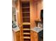 A kitchen featuring wood cabinets, granite countertops, and open shelves for storage at 5400 Roswell Rd # K1, Atlanta, GA 30342