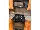 Kitchen appliances featuring a black microwave, and a black oven at 5400 Roswell Rd # K1, Atlanta, GA 30342