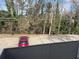 A parking lot with a single red car parked; view from an above balcony at 5400 Roswell Rd # K1, Atlanta, GA 30342