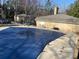 A covered pool in a fenced-in community setting with brick buildings and outdoor seating at 5400 Roswell Rd # K1, Atlanta, GA 30342