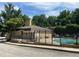 Community pool with a black iron fence, a brick wall and a pool house nearby at 5400 Roswell Rd # K1, Atlanta, GA 30342