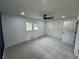 Bright bedroom featuring plush carpeting, a modern ceiling fan, closet, and two windows at 1390 White Oak St Se, Conyers, GA 30013