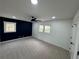 Spacious bedroom featuring plush carpeting, a modern ceiling fan, and two bright windows at 1390 White Oak St Se, Conyers, GA 30013