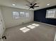 Spacious bedroom featuring carpet, ceiling fan, and natural lighting at 1390 White Oak St Se, Conyers, GA 30013