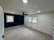 Spacious bedroom featuring plush carpeting, a modern ceiling fan, and two bright windows at 1390 White Oak St Se, Conyers, GA 30013