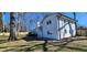 Back exterior of a white brick home featuring a deck, well-kept lawn, and wooden fence at 1390 White Oak St Se, Conyers, GA 30013