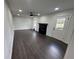 Sunlit living room with dark wood floors, a modern fireplace and a walk-out door to the deck at 1390 White Oak St Se, Conyers, GA 30013