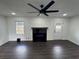 Bright living room featuring dark wood flooring and modern fireplace with contemporary ceiling fan at 1390 White Oak St Se, Conyers, GA 30013