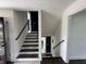 Elegant staircase featuring a dark wooden handrail and white walls at 1390 White Oak St Se, Conyers, GA 30013