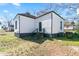 Backyard view of home featuring a rear entry with stairs and a well-maintained lawn at 1820 Spring St, Conyers, GA 30012