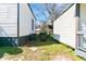 View of the home's backyard and exterior features including siding and utilities at 1820 Spring St, Conyers, GA 30012