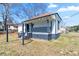 Exterior view of a cozy home with a inviting front porch and a small yard, creating a welcoming curb appeal at 1820 Spring St, Conyers, GA 30012