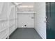 Well-organized laundry room features built-in shelving, side door entry, and bright white walls at 1820 Spring St, Conyers, GA 30012