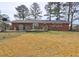 Spacious backyard featuring a deck, storage shed, and a lush lawn, perfect for outdoor activities at 2924 Vogue Dr, Douglasville, GA 30134