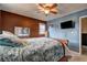 Relaxing bedroom with blue and brown walls, a ceiling fan, and a bed with floral patterned comforter at 2924 Vogue Dr, Douglasville, GA 30134