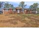 Inviting single-story brick home with a covered porch, set on a spacious lot with mature trees at 2924 Vogue Dr, Douglasville, GA 30134