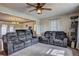 Spacious living room featuring dual sofas, neutral carpet, and a ceiling fan for added comfort at 2924 Vogue Dr, Douglasville, GA 30134