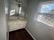 Bathroom with a vanity, sink, and a mirror, enhanced by natural light from the window at 57 Haven Ridge Dr, Carrollton, GA 30116