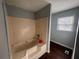 Full tub-shower combo in the bathroom, complemented by a window for natural light at 57 Haven Ridge Dr, Carrollton, GA 30116