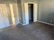 Bedroom featuring carpet, doors to the closet and bathroom, and neutral walls at 57 Haven Ridge Dr, Carrollton, GA 30116