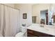 Clean bathroom with a shower, toilet, vanity, and a mirror at 327 Alderwood Ln, Atlanta, GA 30328